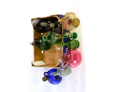 # Five 19th century coloured glass decanters, cranberry glass decanter, an amber tinted decanter, a glass beer bottle and two