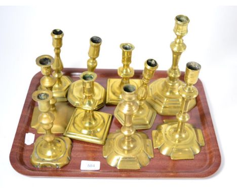 A 17th century brass candlestick on claw feet, height 19cm, a Dutch capstan candlestick, height 13cm and a tray of assorted 1