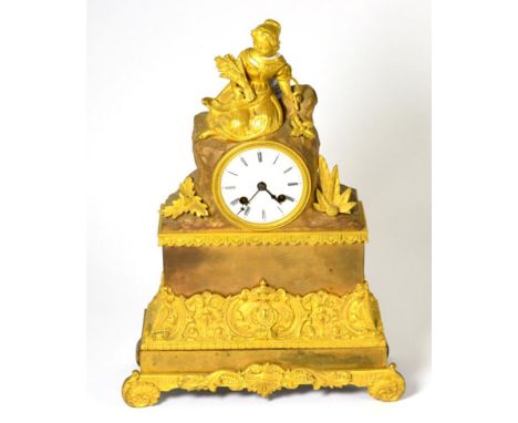 A gilt metal striking mantel clock, circa 1840, surmounted by a harvest lady, enamel dial with Roman numerals, twin barrel mo