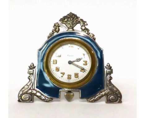 * A enamel 8-day strut timepiece, circa 1930, surmounted by an urn of flowers, guilloche enamel borders, back strut, white en