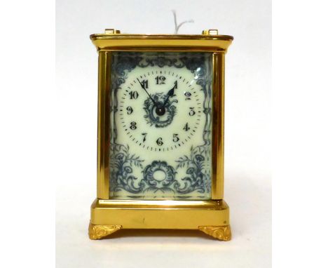 * A brass carriage timepiece, circa 1900, carrying handle, enamel dial with Arabic numerals and surrounded by scroll and flor