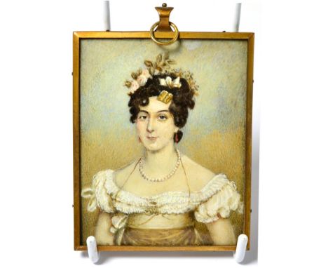 An early 19th century rectangular portrait miniature on ivory, depicting a young woman, half length, wearing a lace-trimmed s