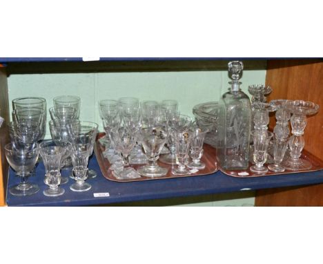Two shelves of 19th century and later glass ware, including rummers, wine glasses, decanter, candlesticks, and a quantity of 