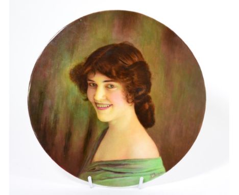 A circular porcelain plaque hand painted with portrait of a lady by James Edwin Dean 