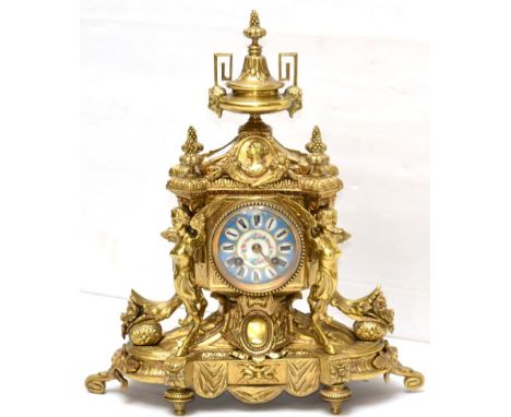 An ormolu striking mantel clock, circa 1890, the elaborate case with floral and figural mounts, enamel dial with Roman numera