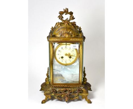 A gilt metal four glass striking mantel clock, circa 1900, scroll and acanthus leaf mounts, enamel dial with Arabic numerals,