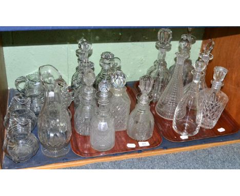 A shelf including fourteen 19th century and later moulded and cut glass decanters with stoppers and seven assorted cut glass 