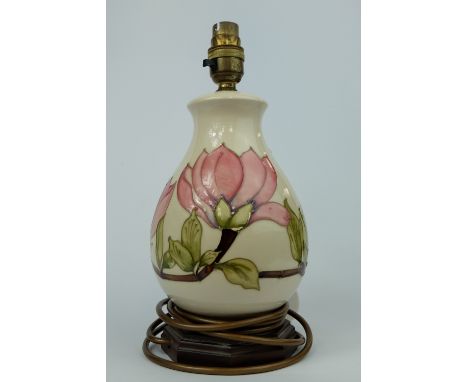 Moorcroft lamp base on wood stand decorated in the Hibiscus design, overall height 29cm