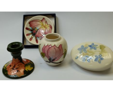 A collection of Moorcroft items including Magnolia vase, oval box & cover, Hibiscus candlestick and boxed dish (4)