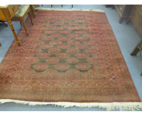 A hand woven Middle Eastern carpet, the centre with multi elephant gulls on a black ground, surrounded by multi-guard borders