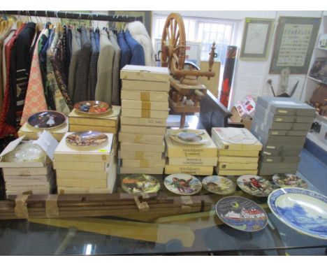 A large selection of collectors plates, plate hangers, and a plate wall hanging shelf unit to include Norman Rockwell plates,