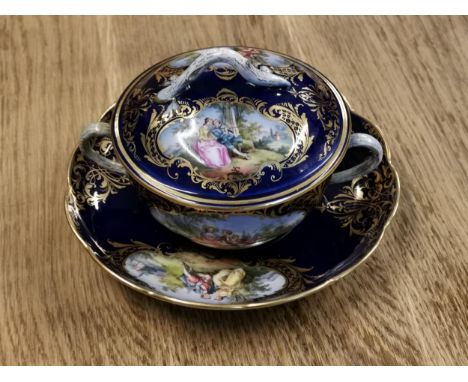 A 19th century Meissen lidded soup bowl and saucer, hand painted with classical romantic scenes on a cobalt blue ground with 
