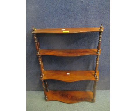 An early 19th century mahogany serpentine front three tier hanging shelf 68cm h x 55cm w Location: Stairs 