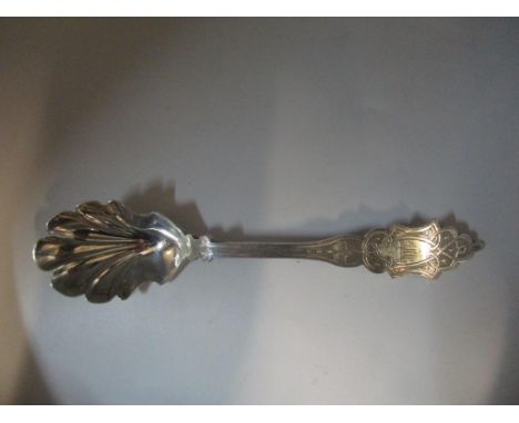 A Victorian Exeter silver long handled caddy spoon or preserve spoon, with shell shaped bowl and engraved decoration and owne