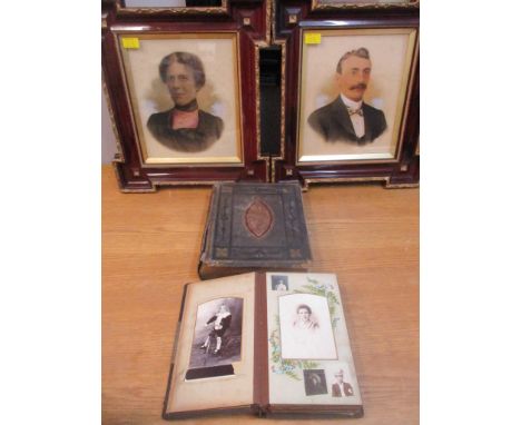 A Victorian leather bound family photograph album with various portrait photographs, a Victorian family bible and two framed 