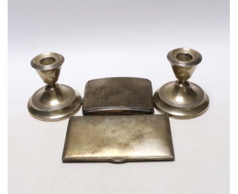 Two engine turned silver cigarette cases, largest 13.5cm and a pair of silver mounted dwarf candlesticks.