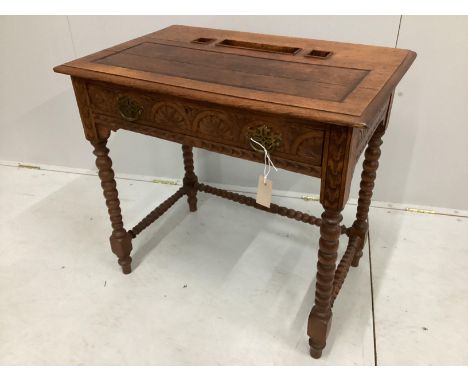 A late 19th / early 20th century lunette carved oak writing table on bobbin legs, width 75cm, depth 48cm, height 70cm