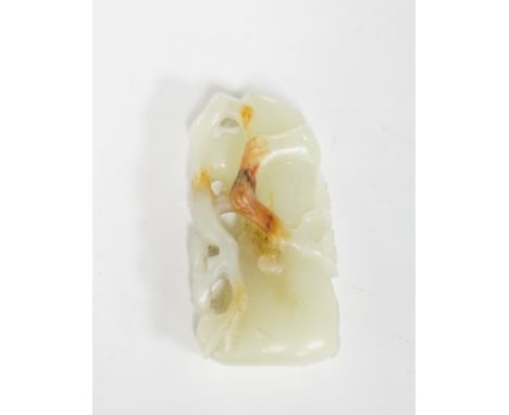 A Chinese pale celadon and russet jade carving of a prunus bough, 5.4cm