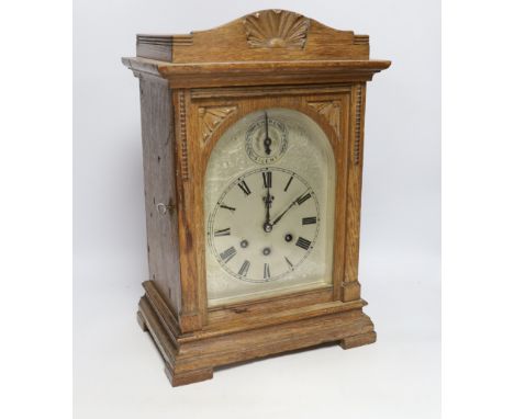 A 1920's Gustav Becker oak bracket clock with three train movement, striking and chiming on five gongs, 42.5cm high