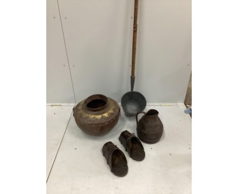 A Victorian ash handled dairy ladle, a coopered oak jug, a pair of Spanish iron mounted stirrups and an Eastern brass mounted