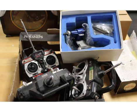 A MODEL AIRCRAFT ENGINE IN AN O.S. SURPASS BOX - UNCHECKED, TOGETHER WITH A SELECTION OF REMOTES ETC