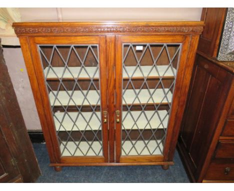 A VINTAGE OAK GLAZED TWO DOOR BOOKCASE W-106 CM