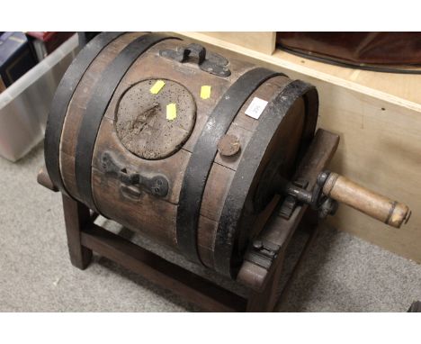 A VINTAGE CHURNING BARREL ON STAND