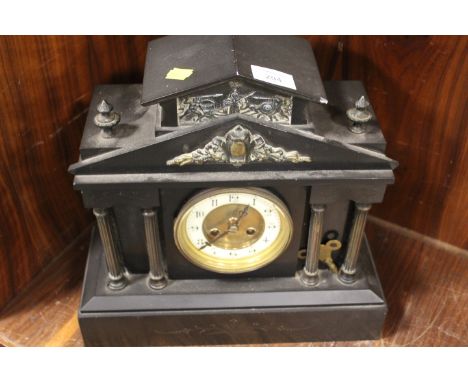 A FRENCH BLACK SLATE MANTLE CLOCK OF ARCHITECTURAL FORM