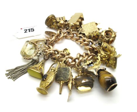 A Large Curb Link Charm Bracelet, to heart shape padlock style clasp, stamped "9ct", suspending numerous 9ct gold and other c