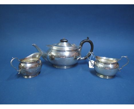 A Matched Hallmarked Silver Three Piece Tea Set, Messrs Hutton, Sheffield 1925, 1926, each of plain oval form with scroll han