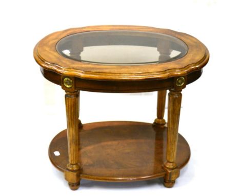 A Walnut Two-Tier Oval Lamp Table, with bevelled glass plate above reeded tapering legs joined by a parquetry decorated shelf