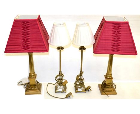 A Pair of Brass Corinthian Column Table Lamps, with fluted supports and stepped bases, red gathered silk shades, height 64cm;