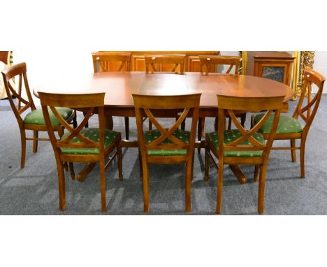 An Eleven Piece Reproduction Cherrywood Dining Suite, comprising oval extending dining table, 181cm by 113cm by 76cm, a set o