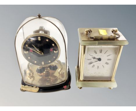 A German mantel clock under glass dome and a further brass and onyx cased quartz mantel clock 