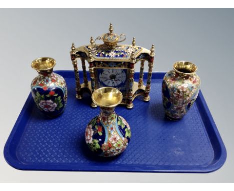 A brass and champleve enamel quartz mantel clock and three similar vases 