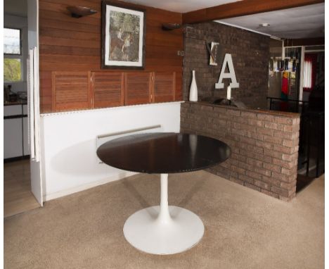 Eero Saarinen (1910-1961) for Arkana Dining table extending black ash top over white enamelled base 74cm high, 121cm wide, 16