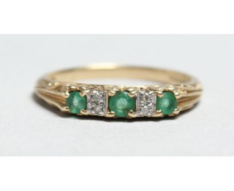 A 9CT GOLD, EMERALD AND DIAMOND RING.