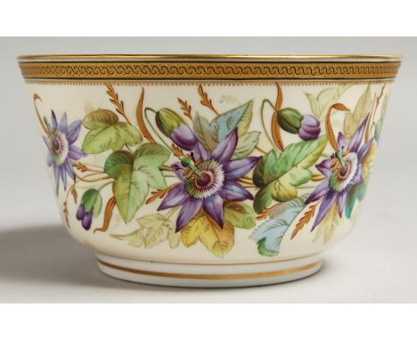 A ROYAL WORCESTER BOWL painted with a gilt and black border painted with passion flowers.