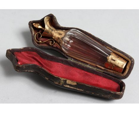 A CUT GLASS GOLD MOUNT EWER SHAPED SCENT BOTTLE IN ORIGINAL LEATHER CASE.