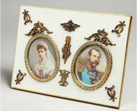 A SUPERB RUSSIAN SILVER AND ENAMEL DOUBLE PHOTOGRAPH FRAME with portrait prints of Alexander II &amp; Empress Alexandra Fedor