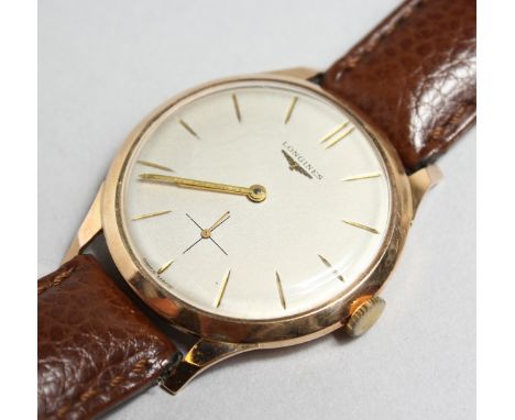 A GENTLEMAN'S LONGINES 18CT GOLD WRISTWATCH, with champagne dial, button numerals and subsidiary seconds dial at six o' clock