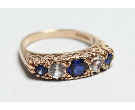 A 9CT GOLD BLUE AND WHITE STONE RING