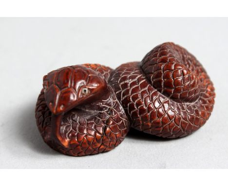 A CARVED WOOD SNAKE NETSUKE, 2ins long.
