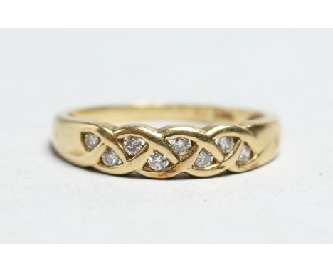 AN 18CT GOLD DIAMOND SET PLAIT RING.