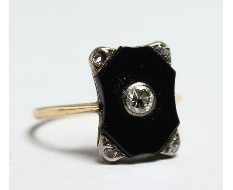 AN ART DECO ONYX AND DIAMOND RING.
