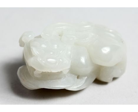 A CHINESE WHITE JADE FO DOG, 2.25ins long.