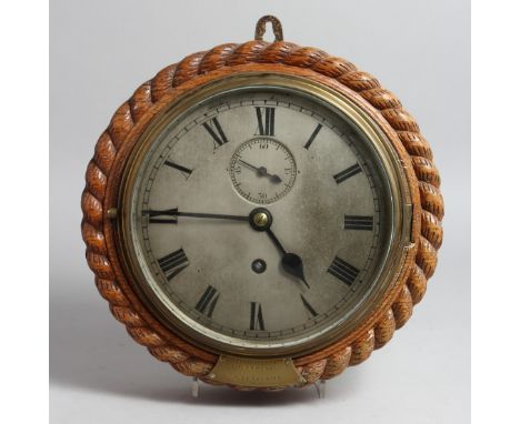 A GOOD OAK CASED CIRCULAR CLOCK with silvered dial, 7.5ins diameter, presented to Officers RAMC, Woolwich, by Col. S. K. RAY,
