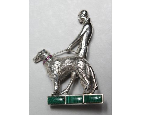 A SILVER MARCASITE AND RUBY SET DECO STYLE LADY WITH DOG.