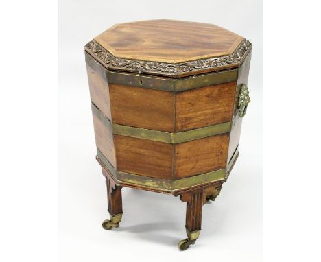 A GOOD GEORGE III MAHOGANY OCTAGONAL SHAPED CELLERETTE  the rising top with carved edge, brass bound sides on four fluted squ