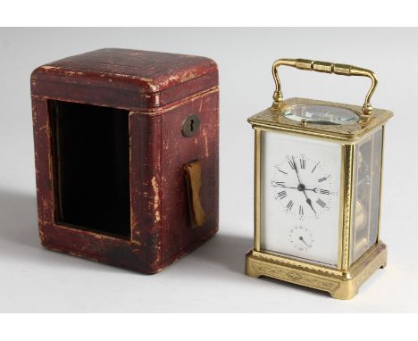 A GOOD FRENCH ENGRAVED BRASS CARRIAGE CLOCK with eight day movement, striking on a gong, enamel dial with subsidiary dial and